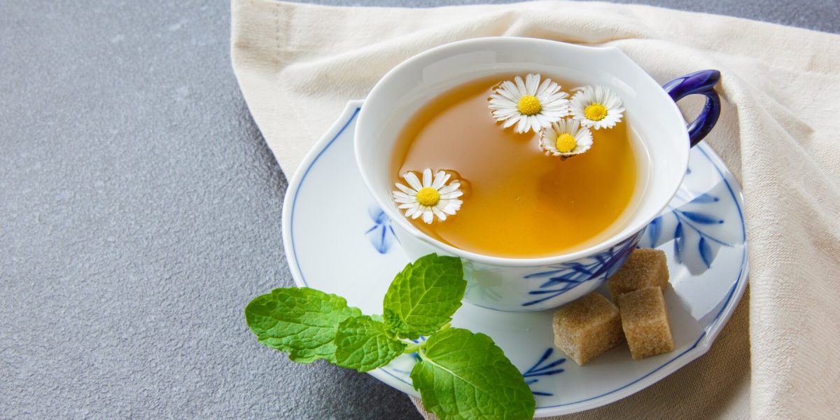 cup-chamomile-tea-with-sugar-cubes-leaves-high-angle-view-cloth_176474-4695