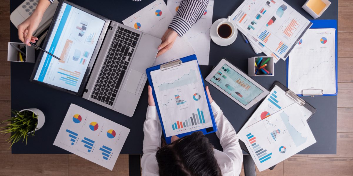 top-viewtop-view-manager-employee-doing-teamwork-business-office-looking-charts-laptop-display